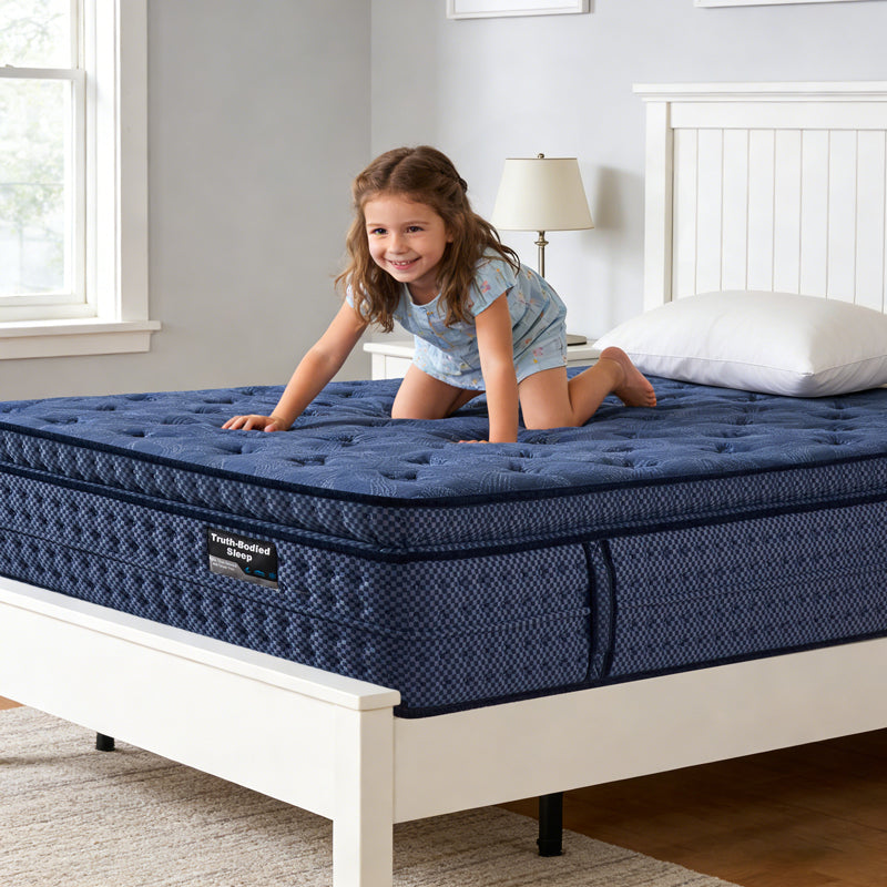 Child playing on a blue mattress in a bedroom