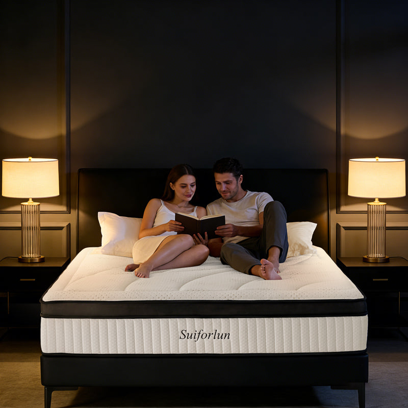 Couple reading on a Suiforlun mattress in a dimly lit bedroom.